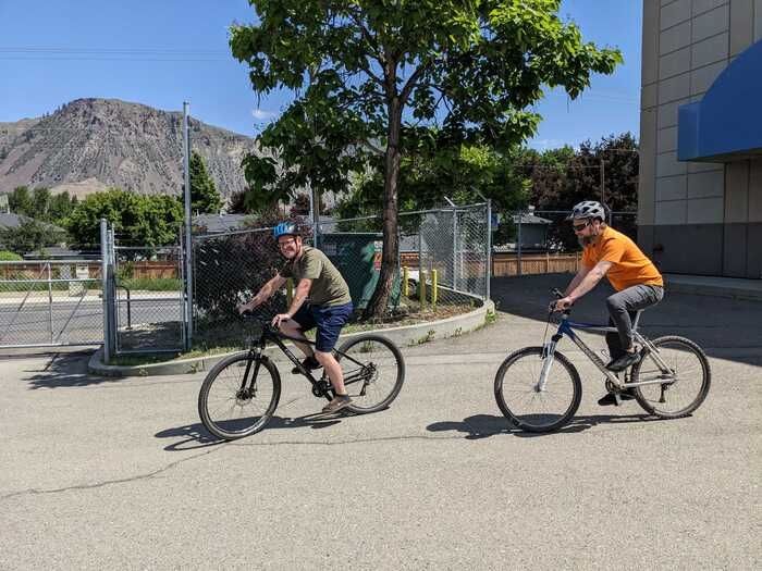 Mike and Andrew on bikes in SilverServers parking lot during Go By Bike BC week